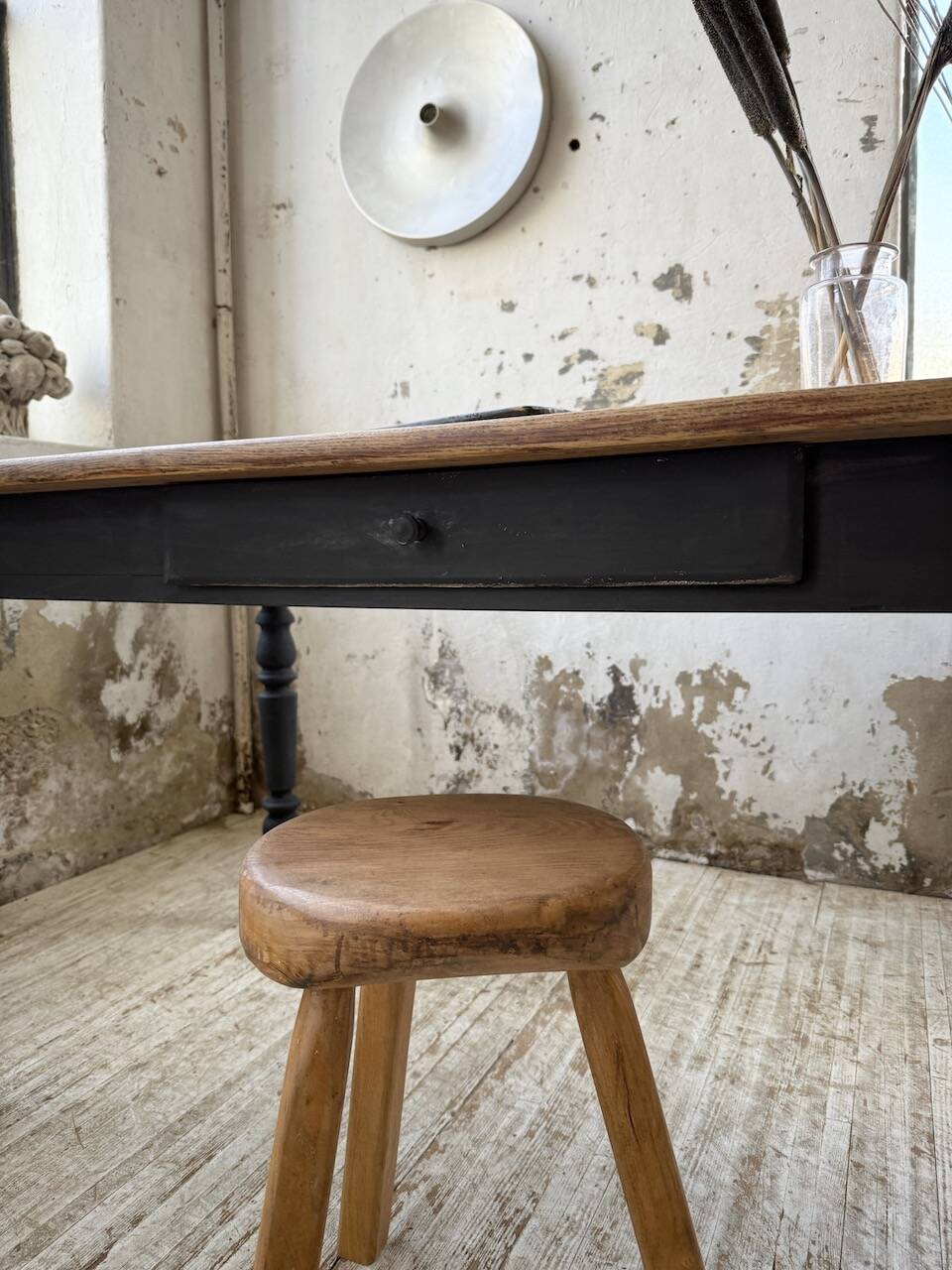 Oak farmhouse table with turned black legs.