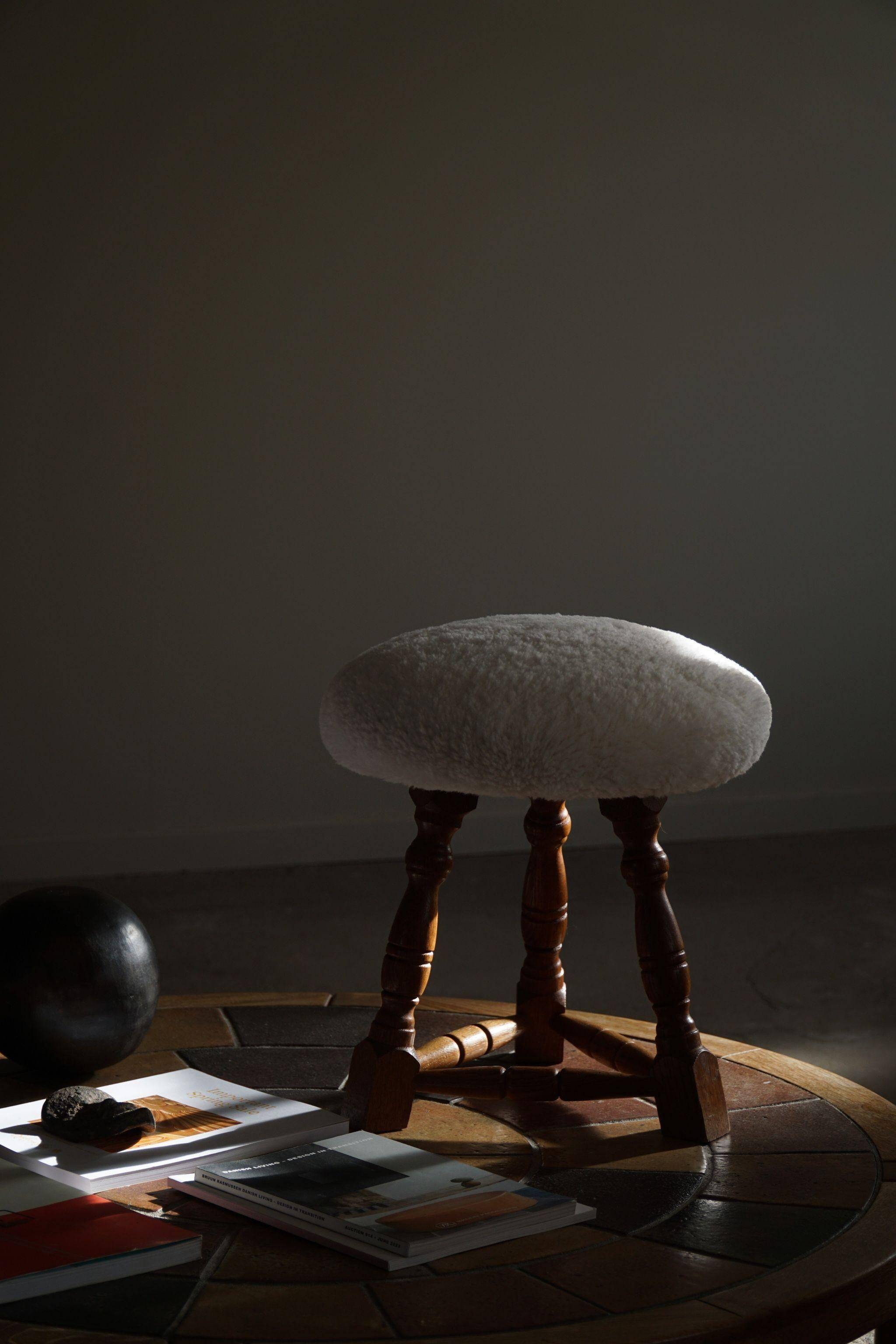 Modern Danish, a pair of tripod stools, seats reupholstered in lambswool, 1950s.