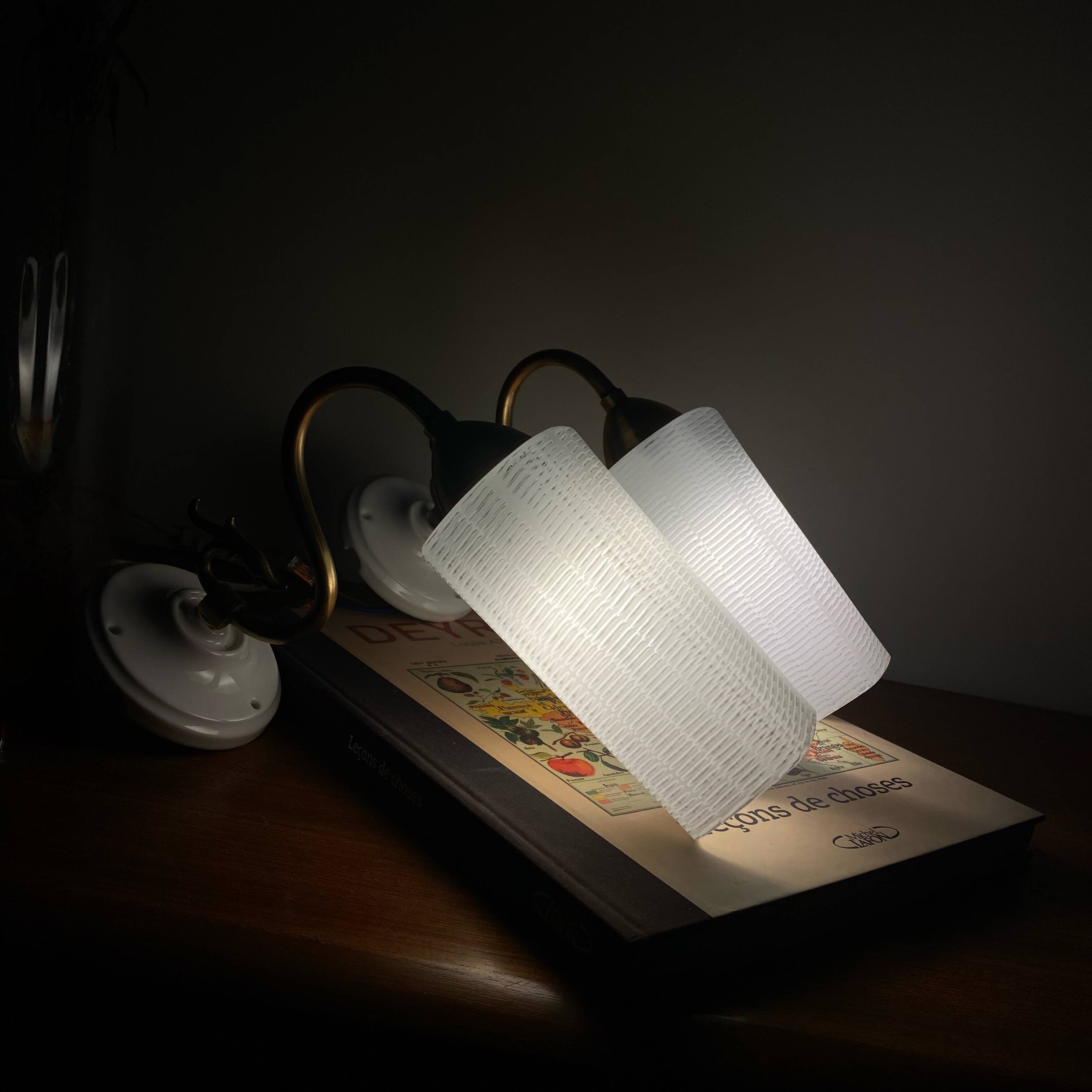 Pair of swan neck wall lights in brass, white glass and porcelain.