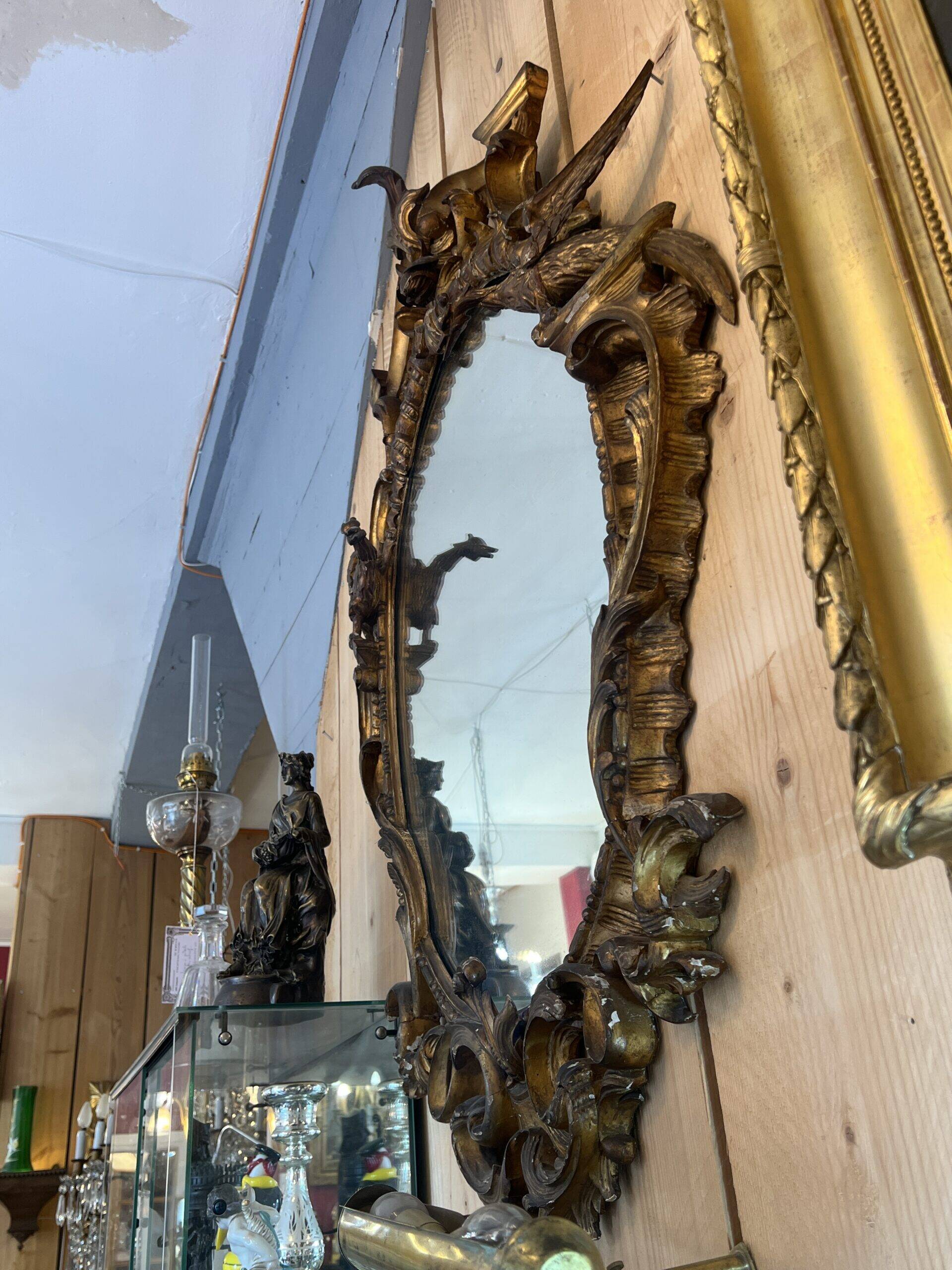 Large gilded wooden mirror, richly carved with winged dragons, 19th century