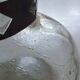 Cracked glass vase encircled with wrought iron.