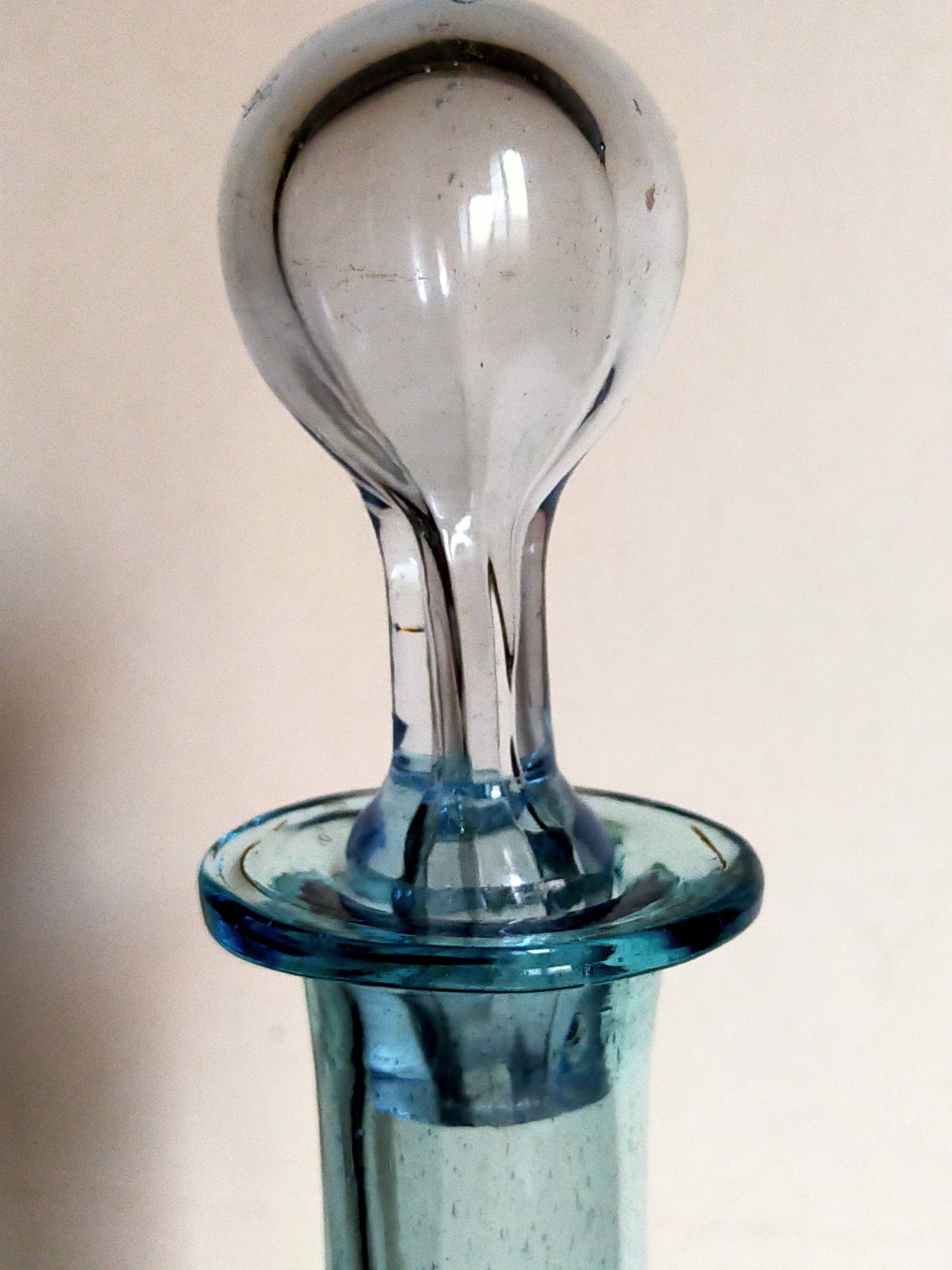 Blue glass carafe with vintage pegs
