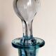 Blue glass carafe with vintage pegs