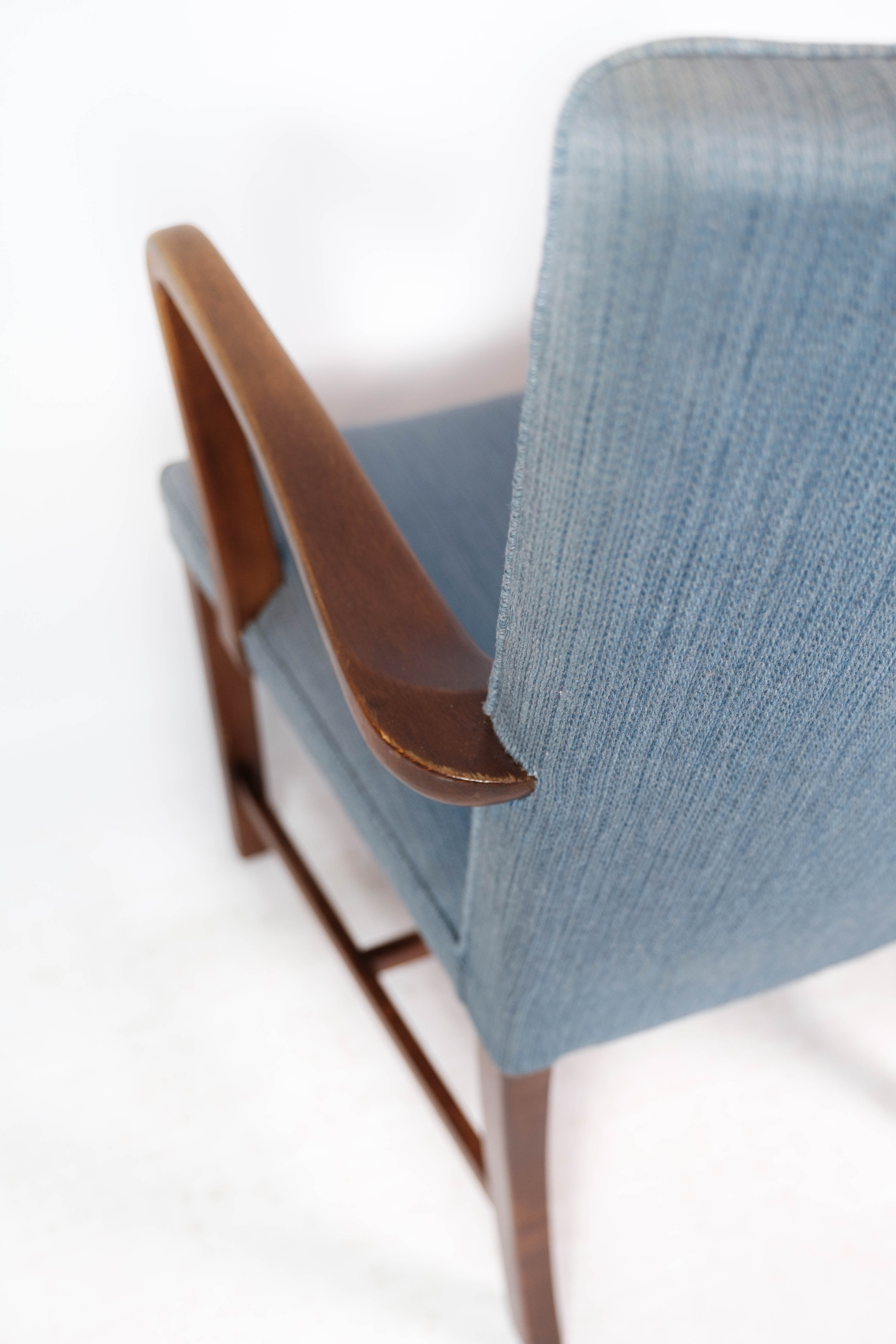 Armchair in mahogany and upholstered with light blue fabric by Fritz Hansen
