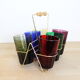 Set of 6 coloured glasses in their brass holder, basket
