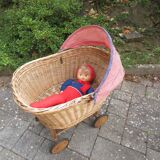 Doll cradle on wicker wheels