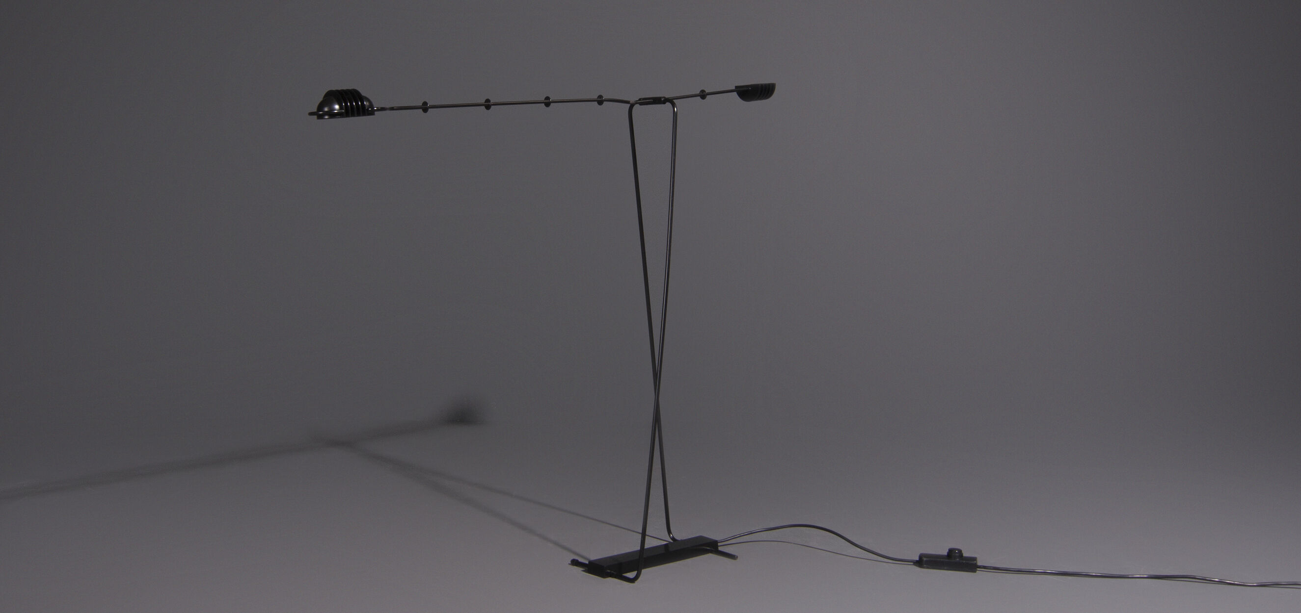 Floor lamp made from black painted metal with balancing arm
