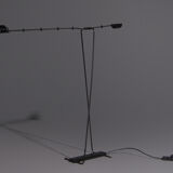 Floor lamp made from black painted metal with balancing arm