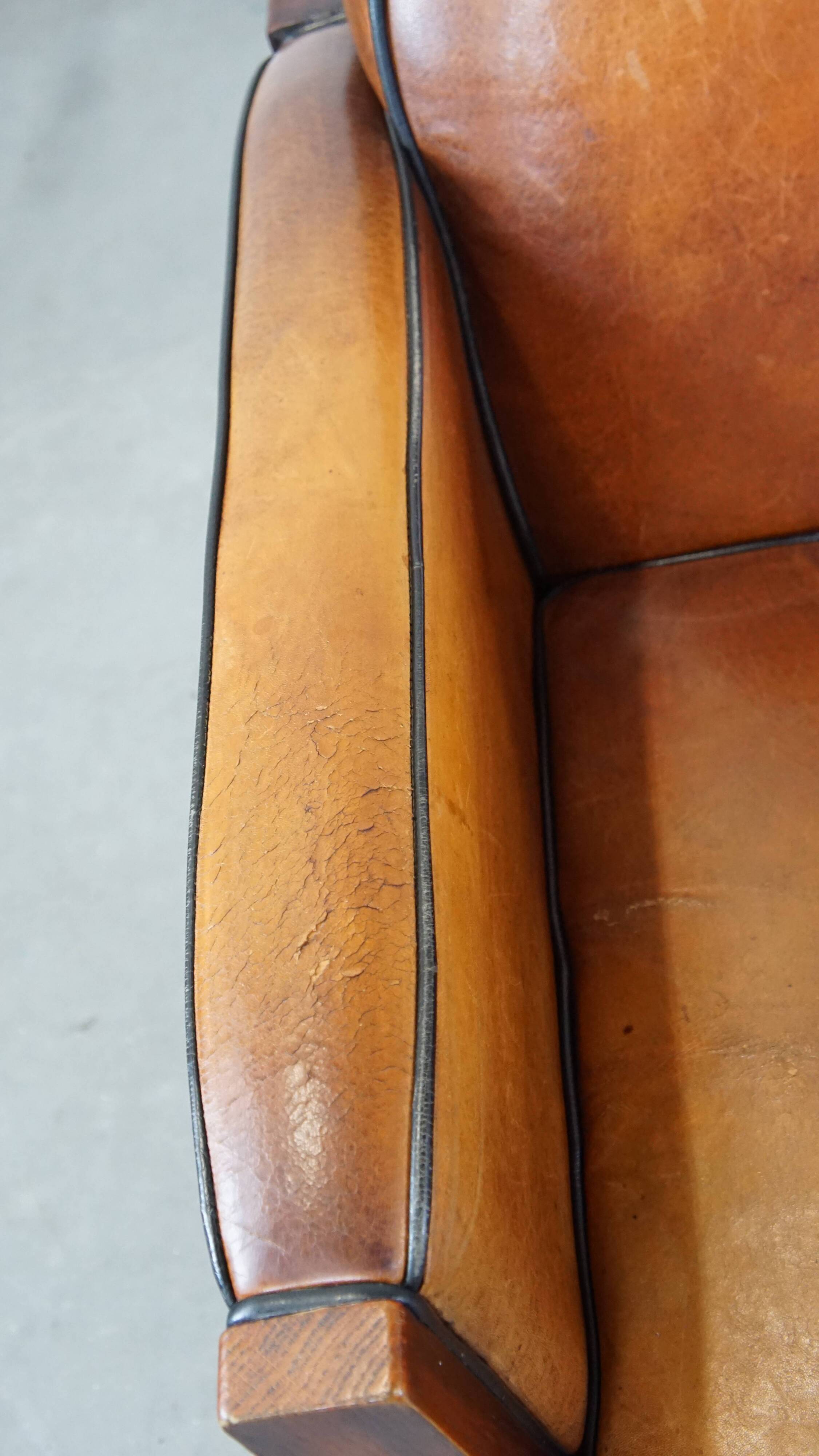 Sheep leather and wooden Art Deco design armchair with ball feet