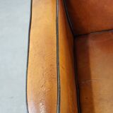Sheep leather and wooden Art Deco design armchair with ball feet