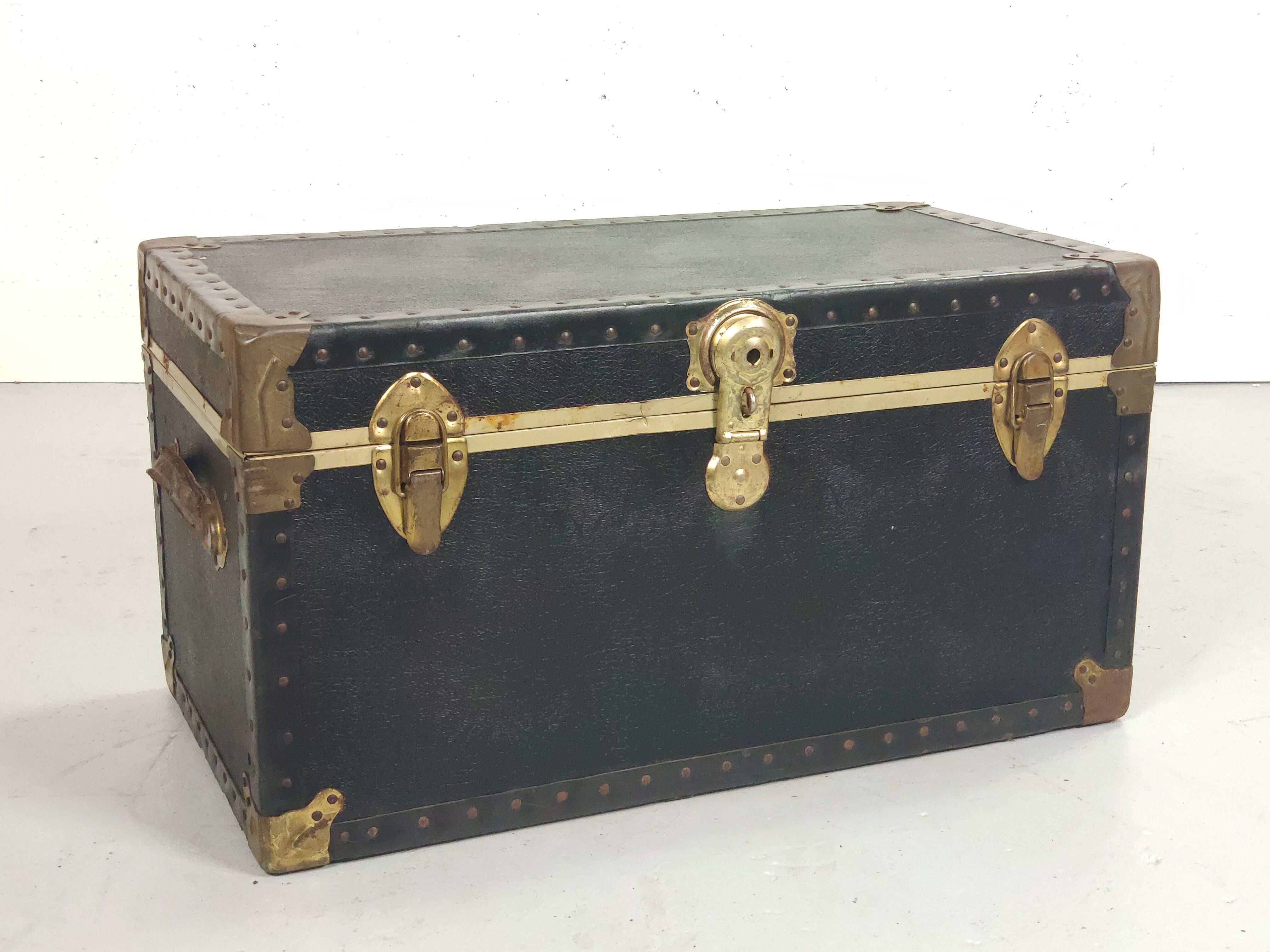 Old black trunk and brass