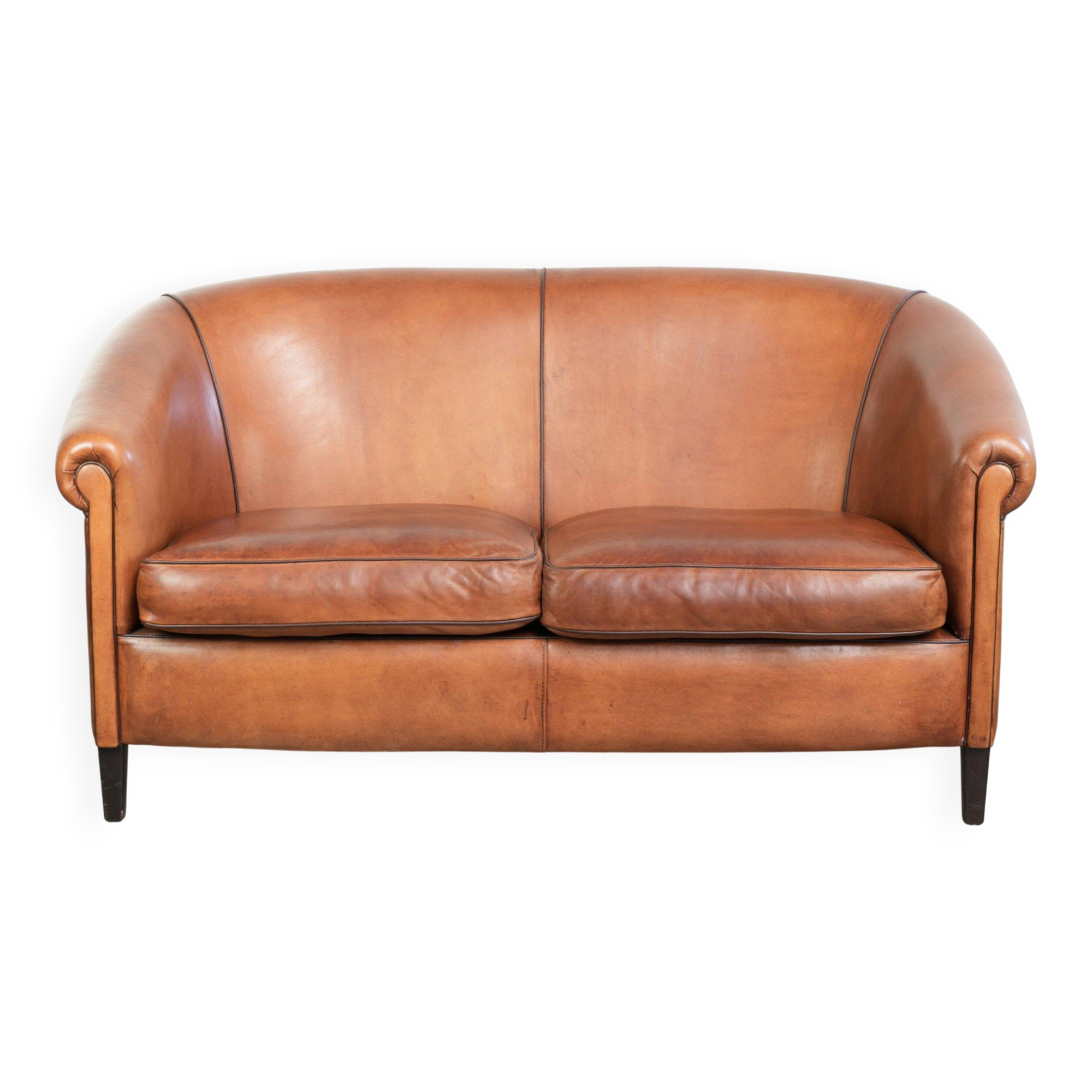 Sheepskin 2-seater sofa with a warm cognac brown colour scheme