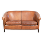 Sheepskin 2-seater sofa with a warm cognac brown colour scheme