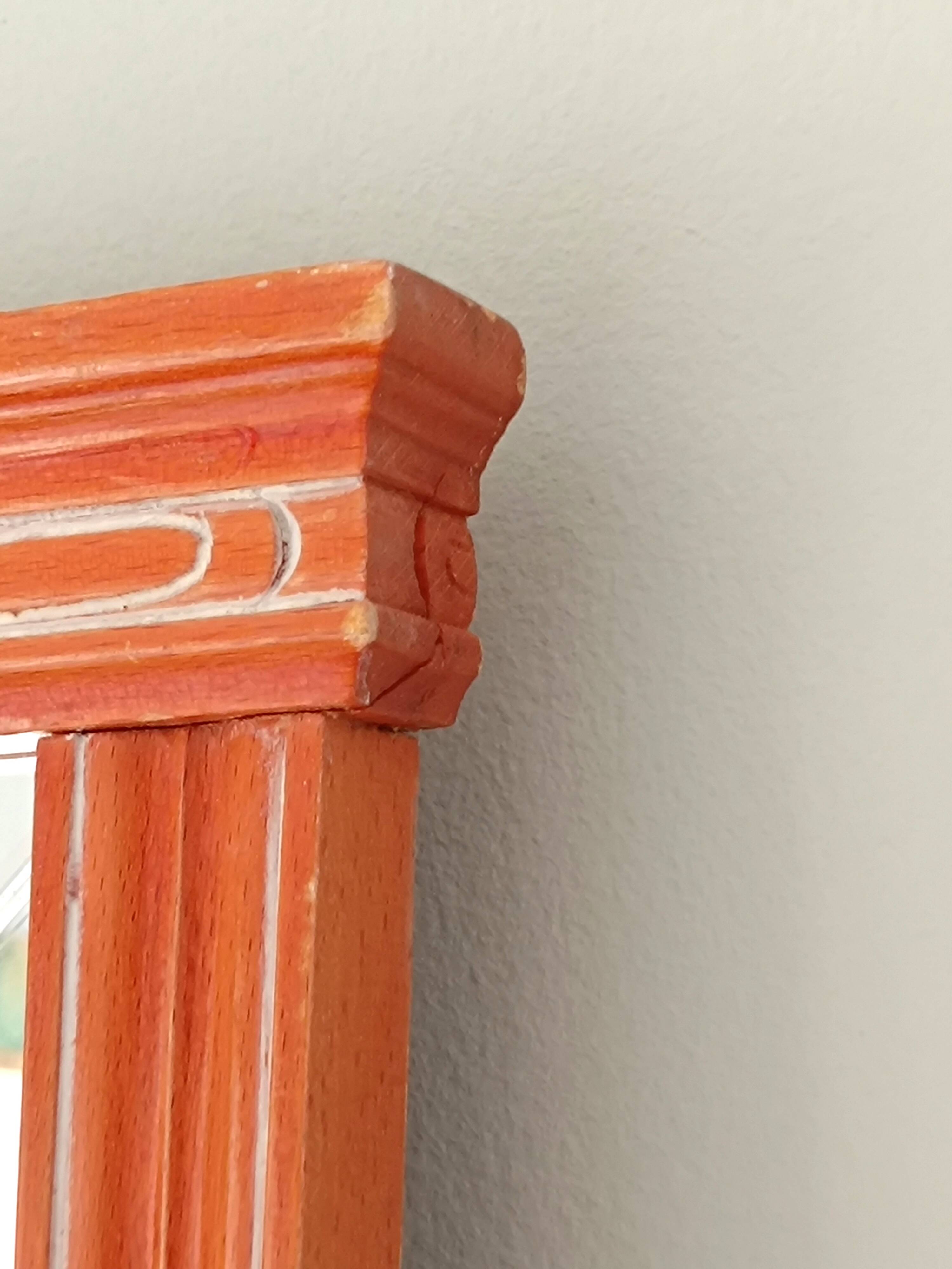 Beveled glass wall mirror in solid wood frame