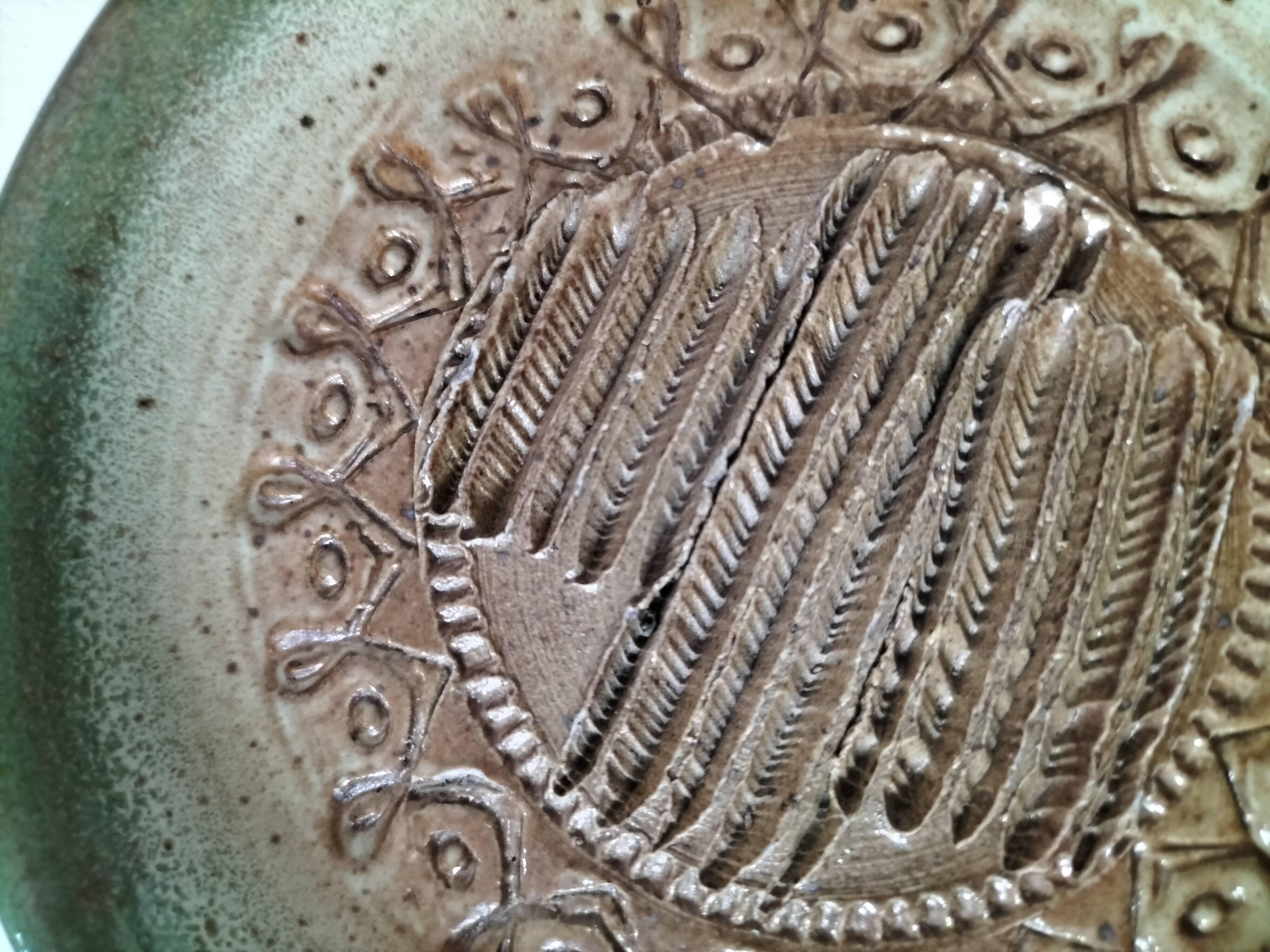 Signed stoneware bowl from Puisaye, relief decoration.