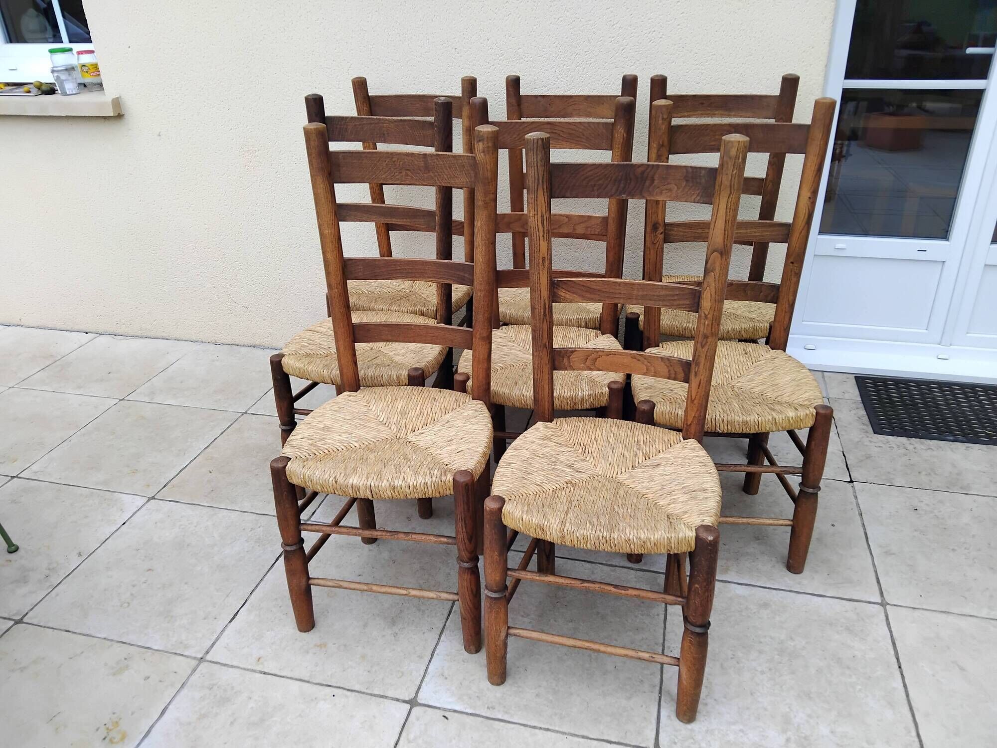 8 vintage straw chairs in the style of Charlotte Perriand.