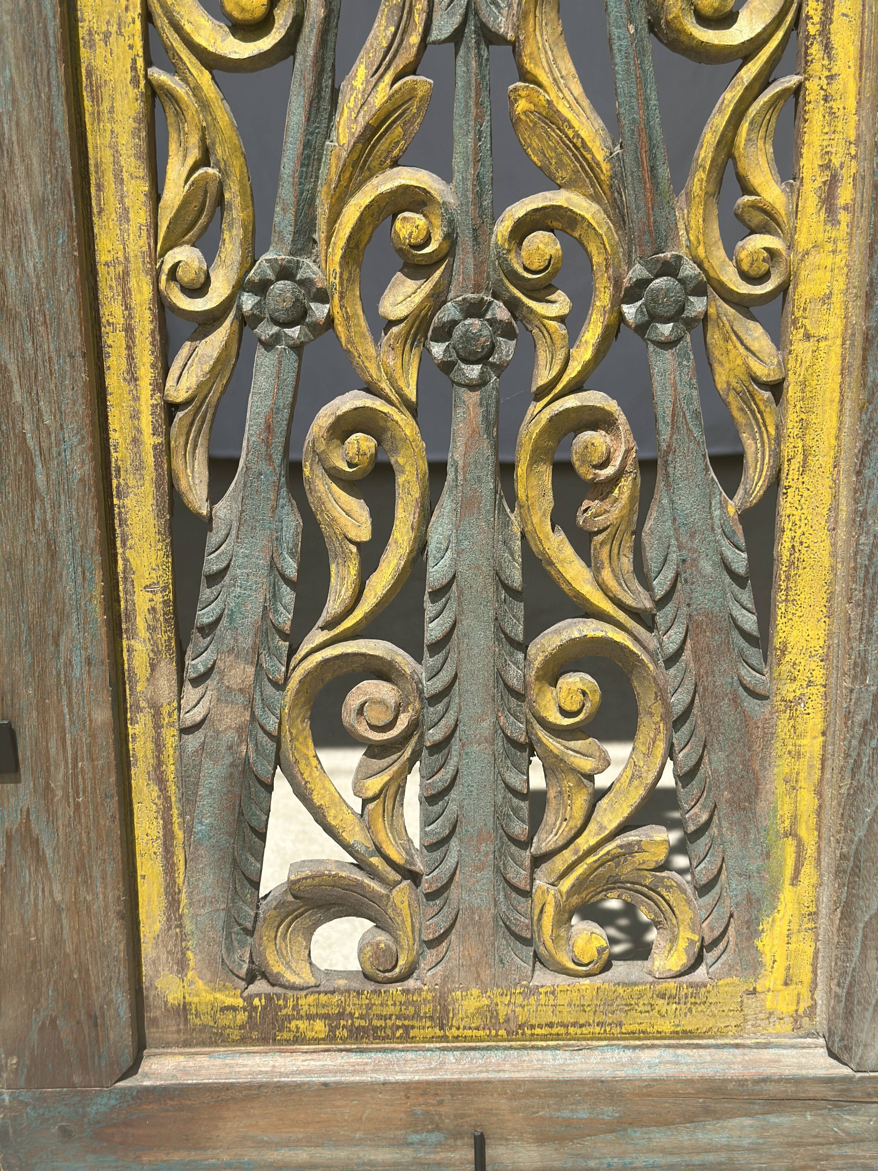 Rectangular Indonesian construction element with blue and yellow plant in carved wood