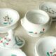 Tableware set in earthenware with floral decoration.
