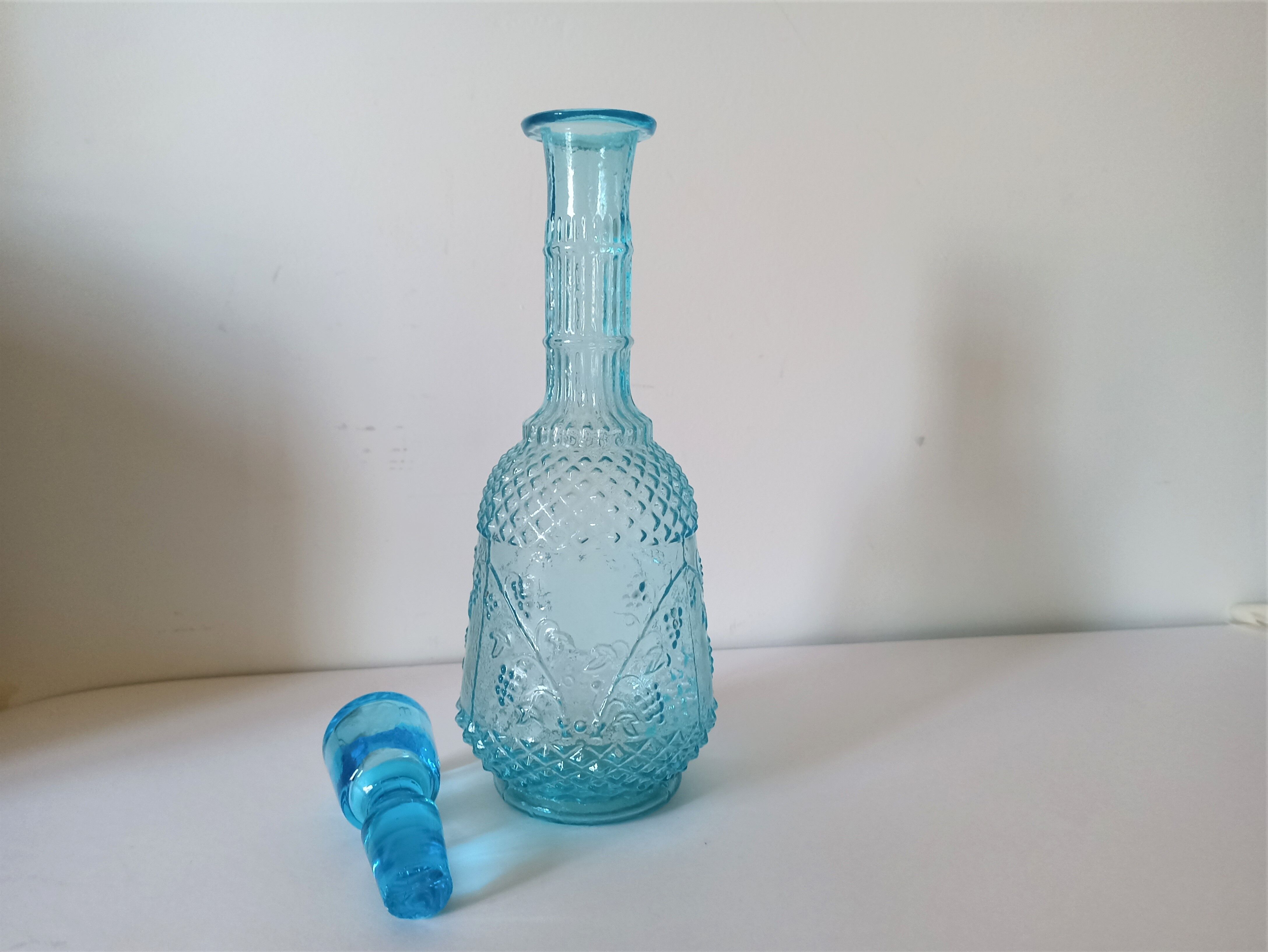 Old turquoise blue molded glass liqueur bottle and its cap
