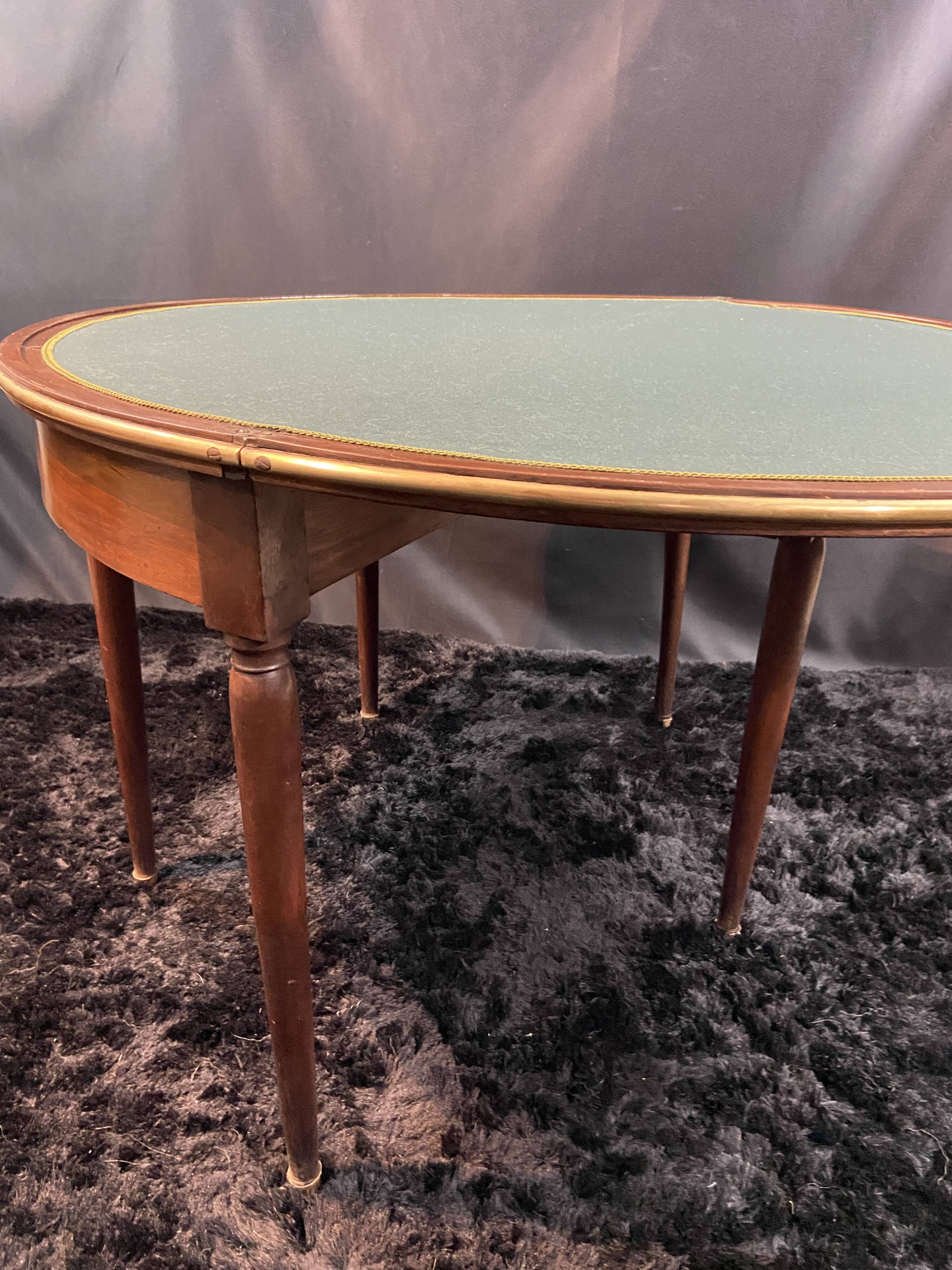 A Louis XVI period mahogany half-moon table forming a console/games table