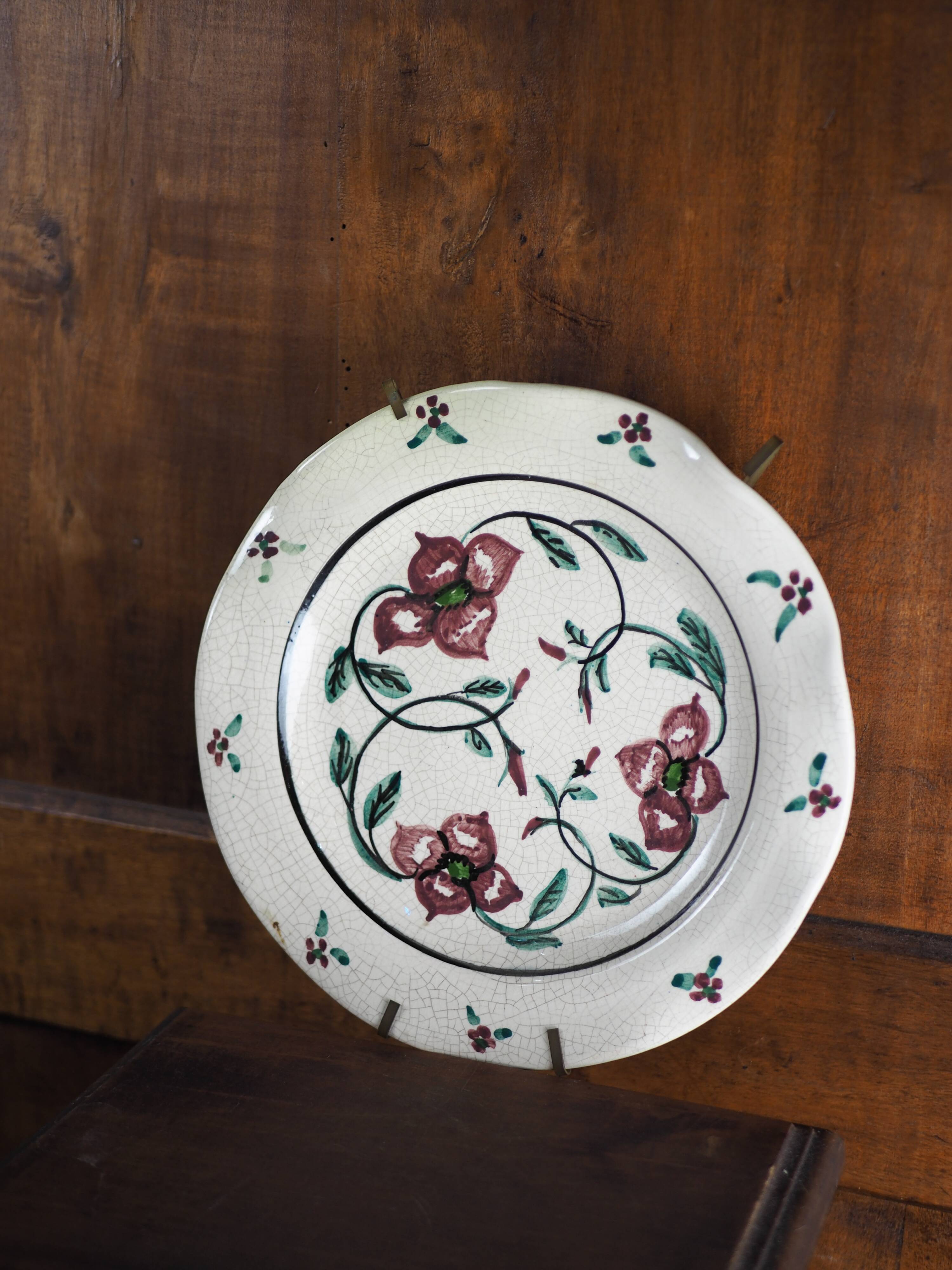 Meyssac plate decorated with flowers on cracked background early twentieth century and its support