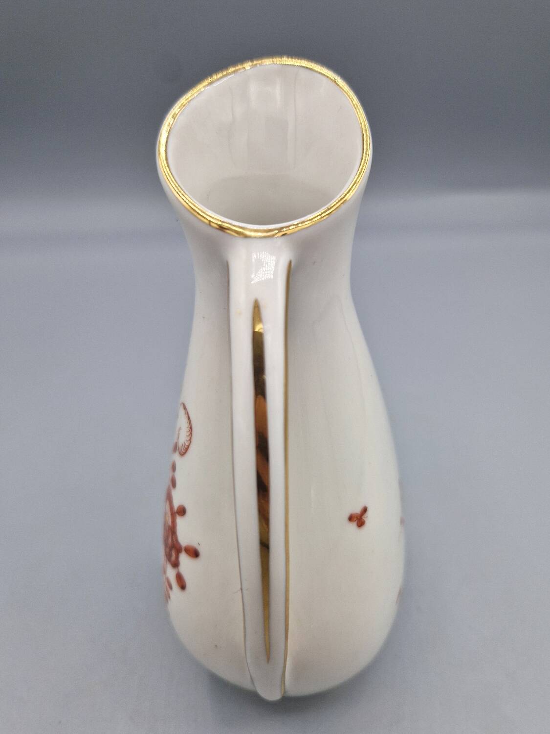 Hand painted German porcelain pitcher with floral design and gold trim