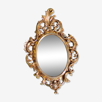 Old mirror with a gilded baroque style frame