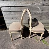 Pair of cerused chairs with fabric seats and caned backs.