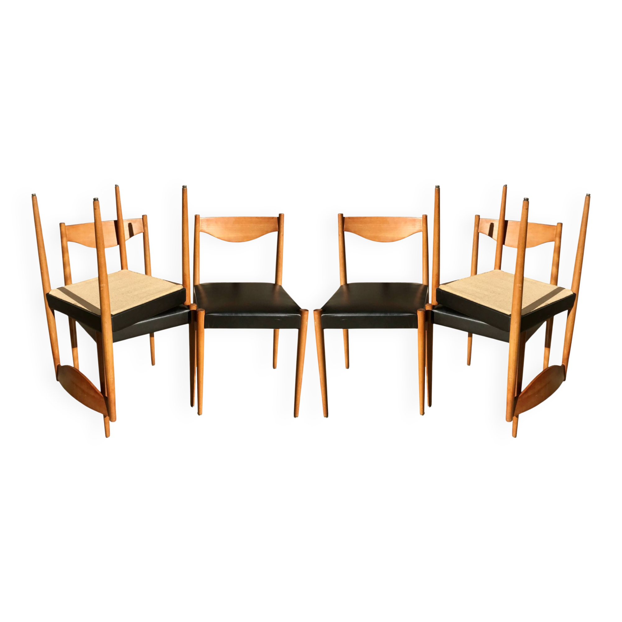 Set of 6 modernist chairs with black faux leather seats.
