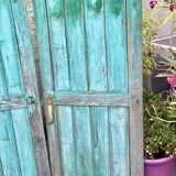 Pair of old wooden shutters green mint color