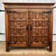 Spanish furniture with carved wood profiles and coats of arms from the 1950s.