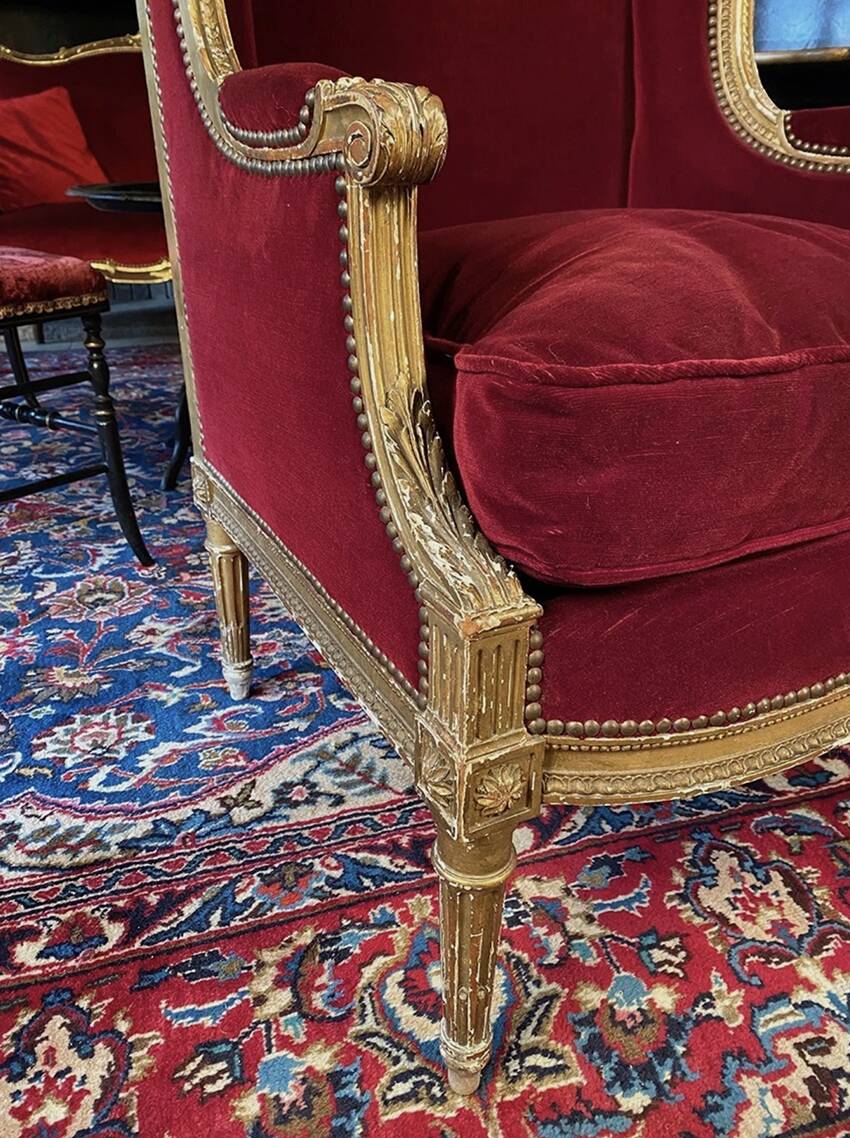 Golden wooden bergère in Louis XVI style upholstered in Bordeaux velvet.