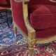Golden wooden bergère in Louis XVI style upholstered in Bordeaux velvet.