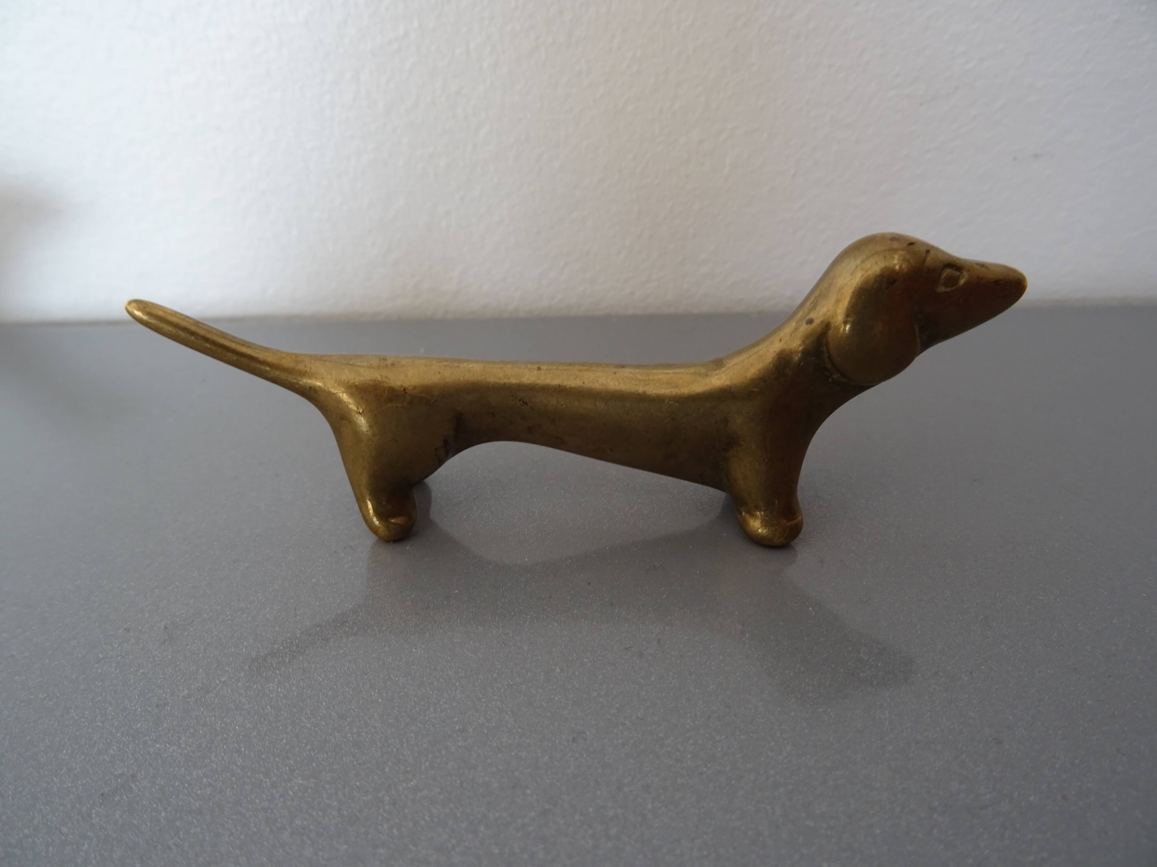 Series of 6 vintage gilded brass dachshund knife holders