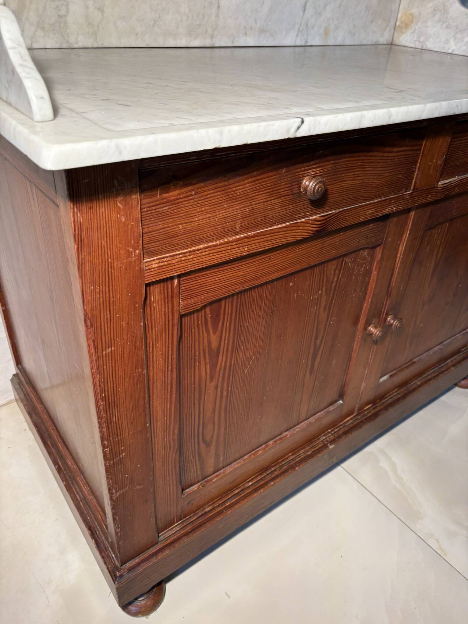 Antique wood and marble kitchen sideboard with carved backsplash