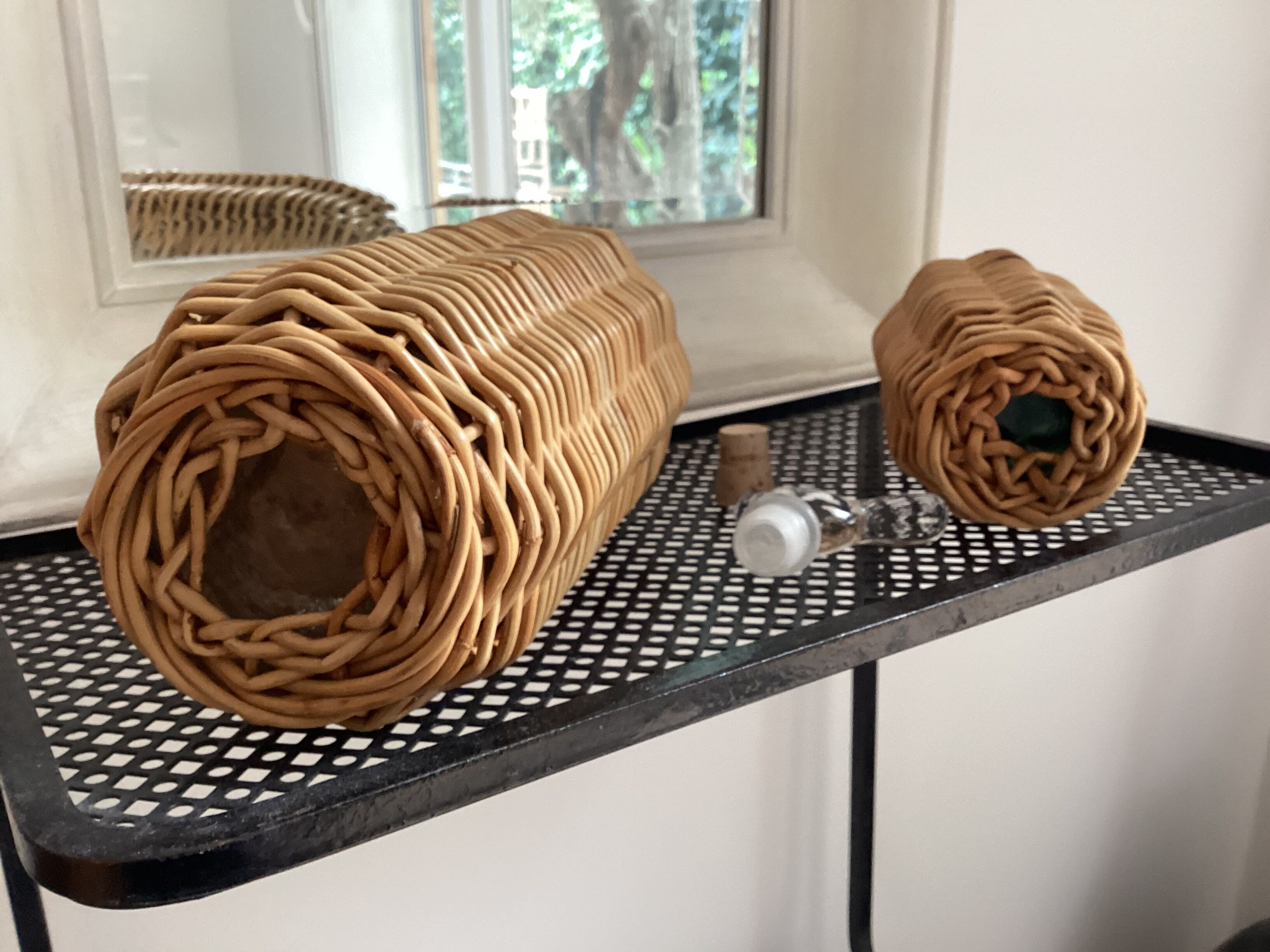 2 glass and rattan bottles