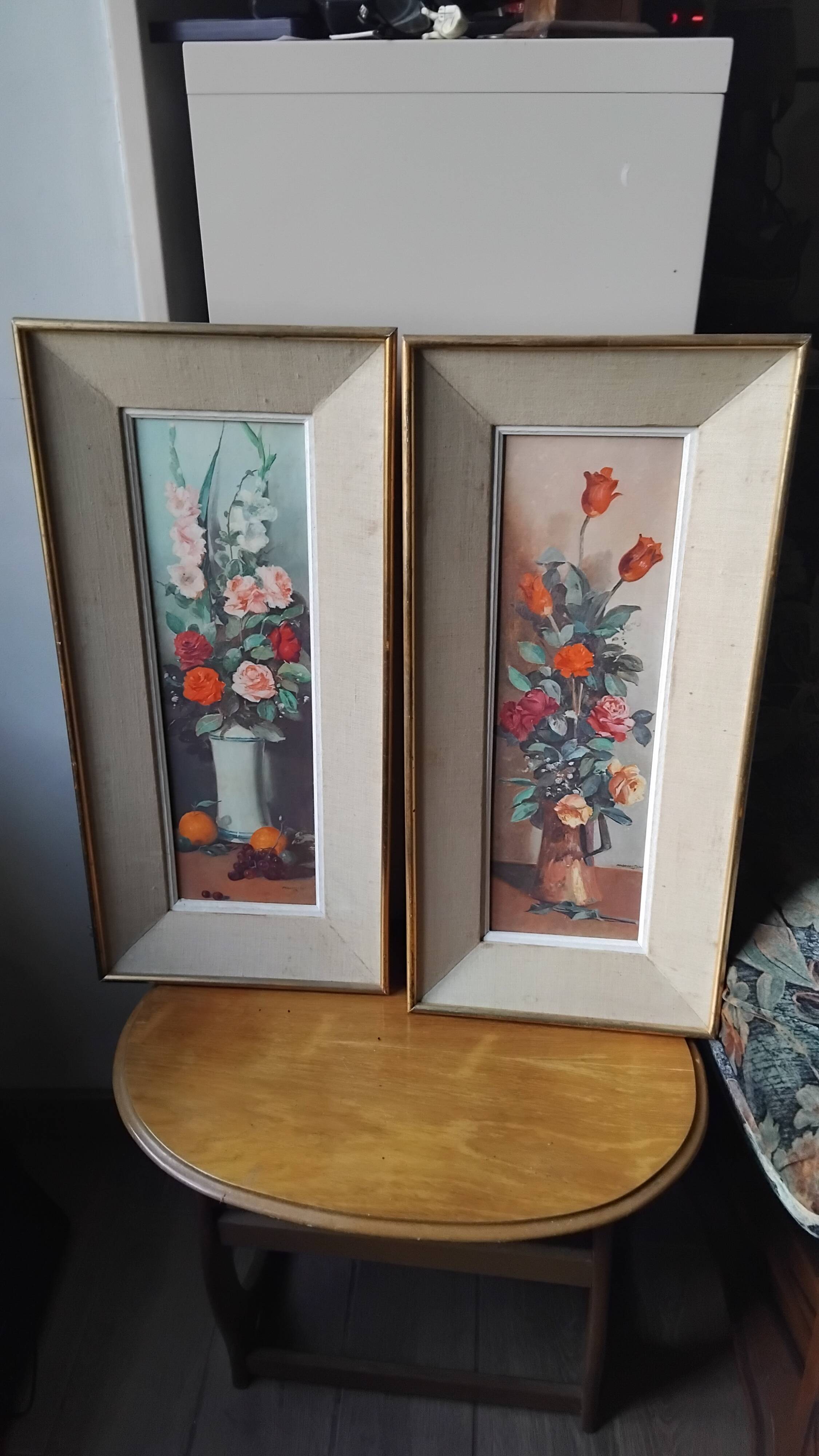 Pair of framed paintings featuring a composition of flowers.
