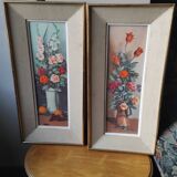 Pair of framed paintings featuring a composition of flowers.