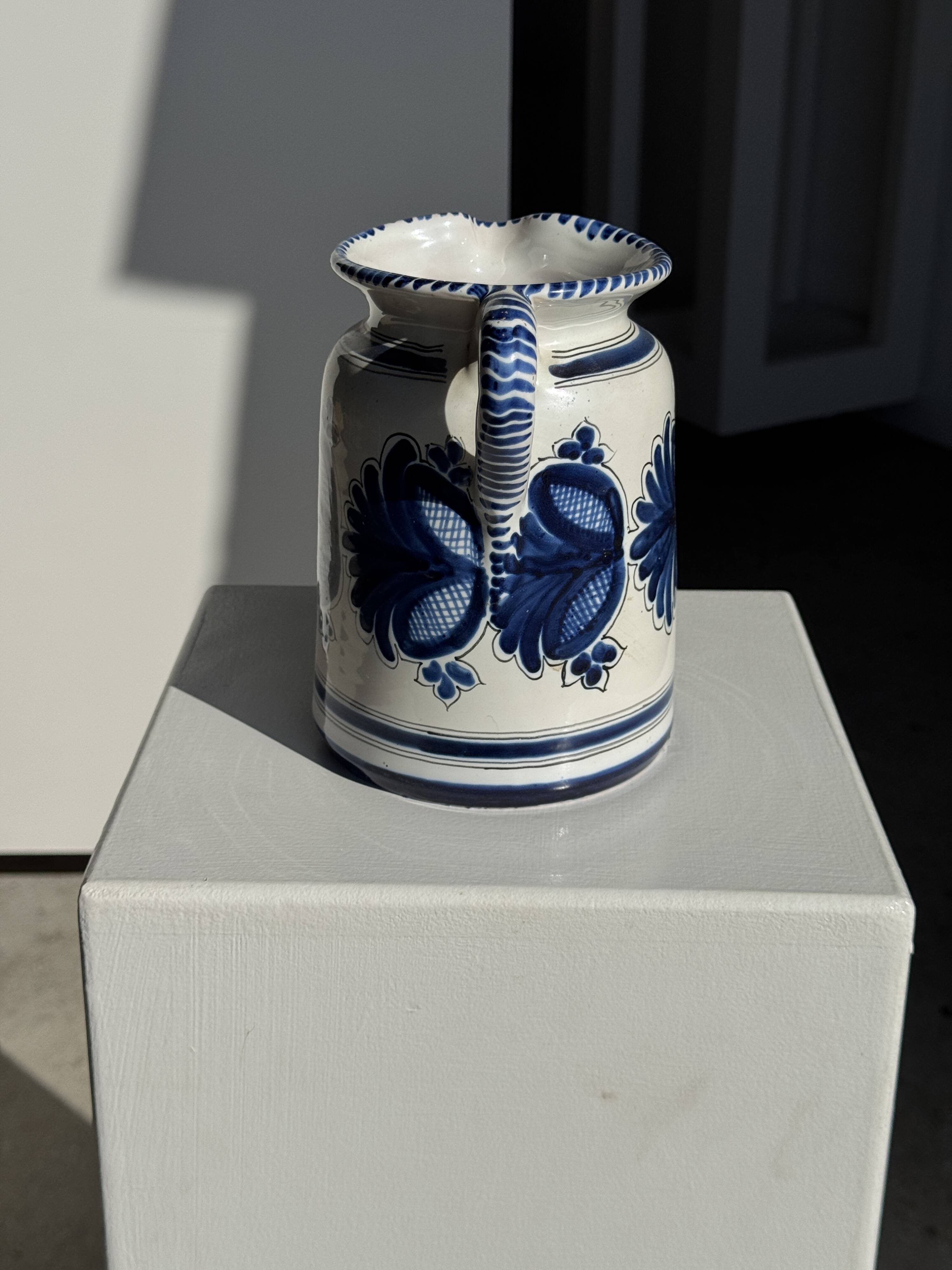Artisan blue floral decorative carafe, height 17 cm, diameter 24.5 cm.