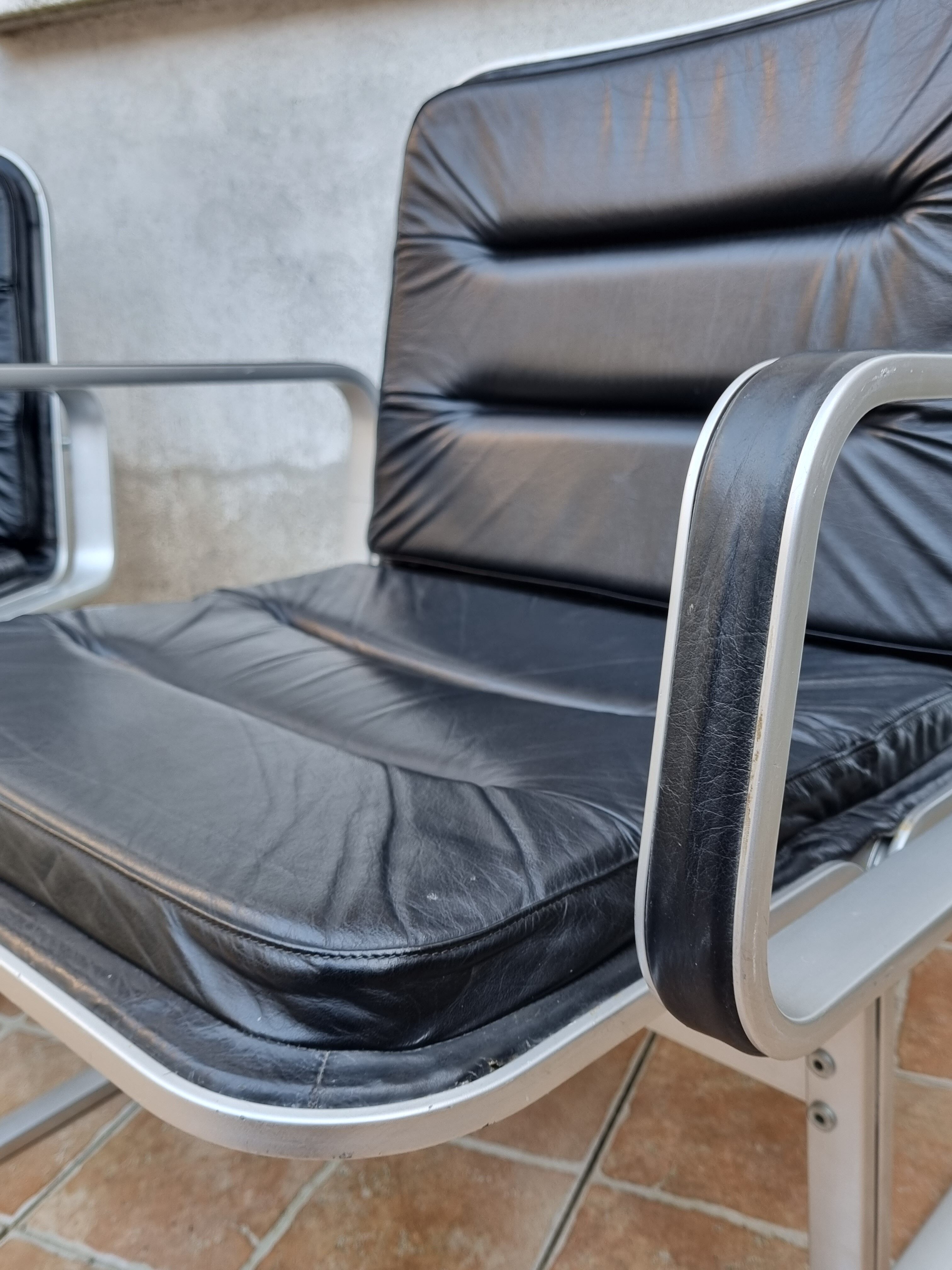 Pair of vintage leather and aluminum armchairs, restored