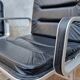 Pair of vintage leather and aluminum armchairs, restored