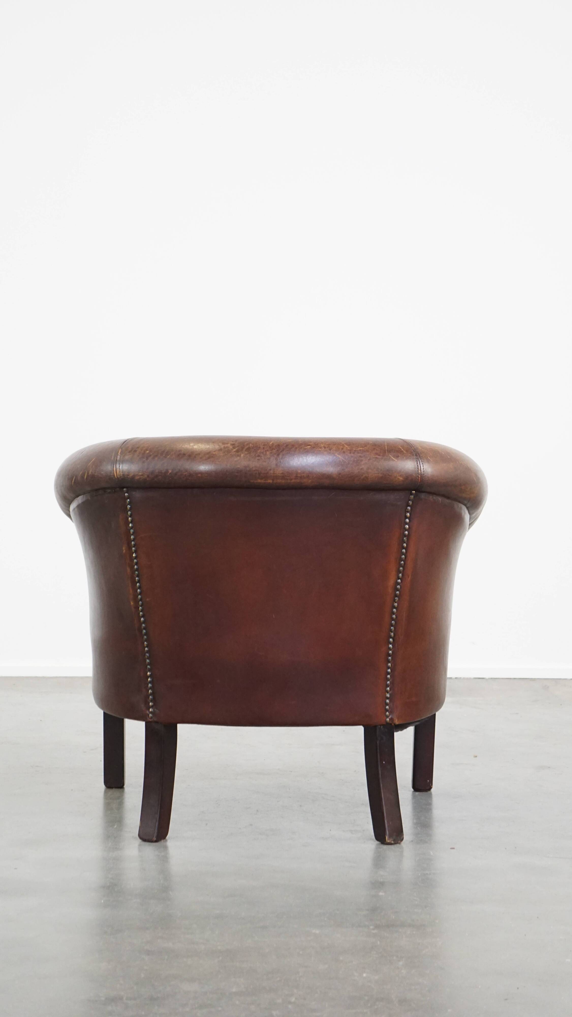 Sheep leather club chair finished with decorative nails