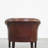 Sheep leather club chair finished with decorative nails