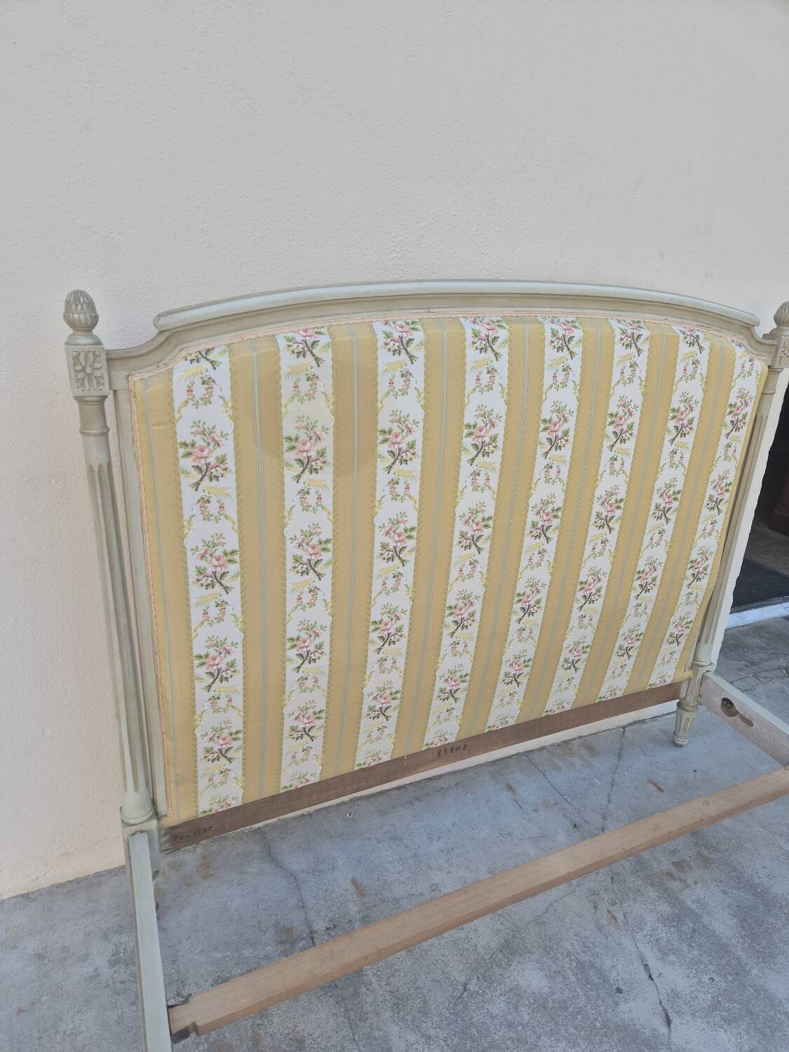 Louis XVI style bed richly decorated in patinated wood.