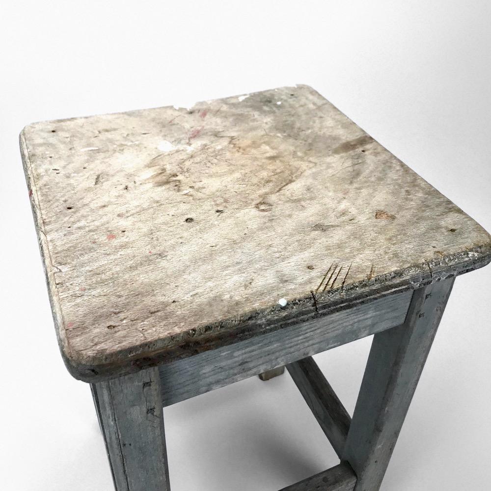 Blue-tinted wooden workshop stool