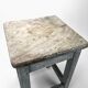 Blue-tinted wooden workshop stool