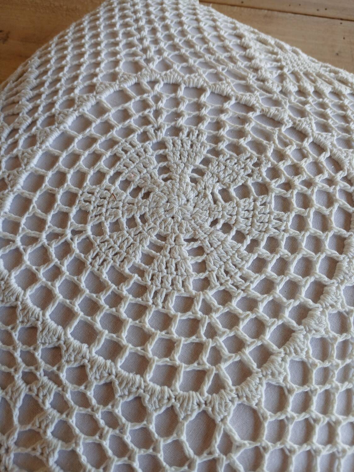 Cushion with white crochet cover