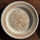 Set of 4 small dessert plates with a vintage stylised flower pattern.