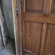 Old solid oak front door with frame and transom from the 19th century.