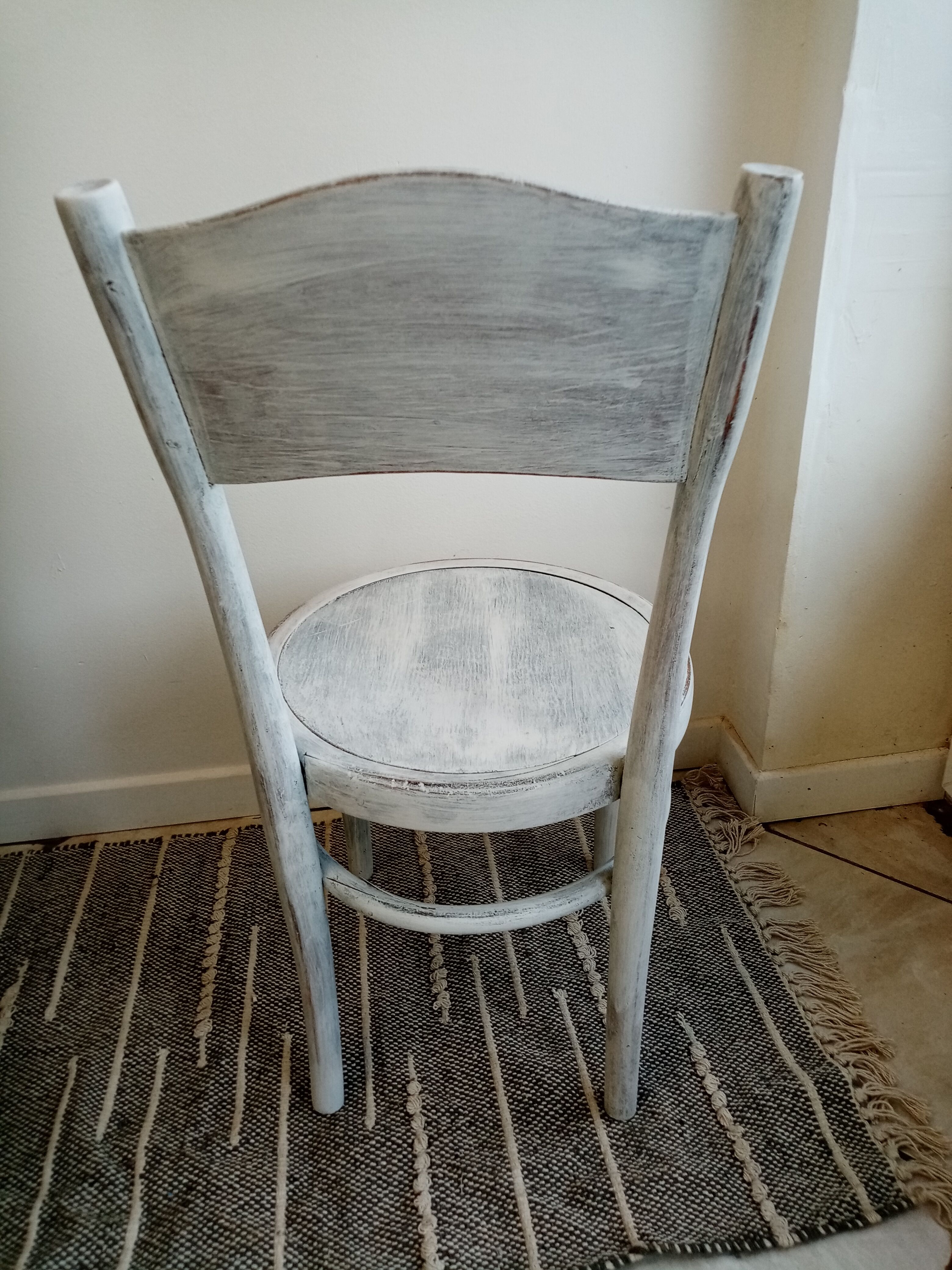 White antique children's chair in patinated wood